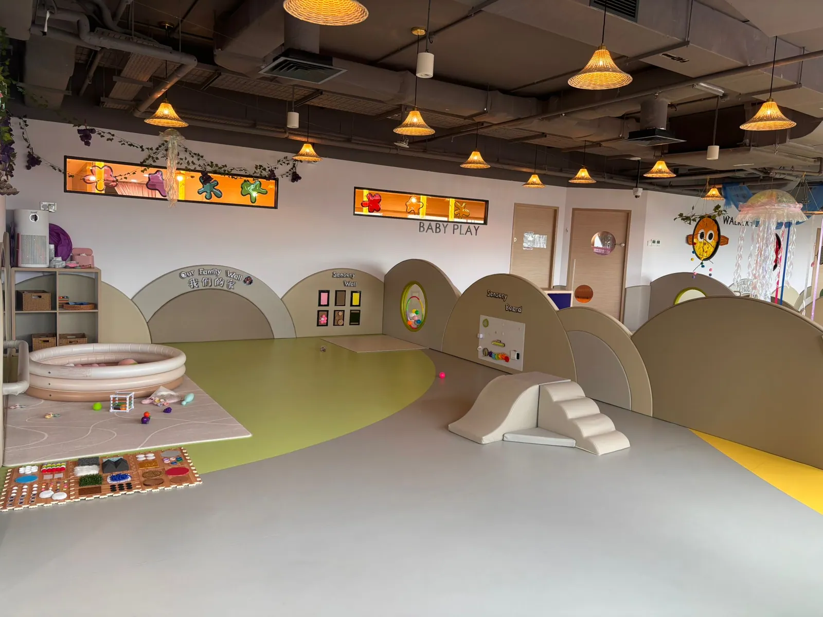 The wide Baby Play room with Our Family Wall, the Sensory Wall and Sensory Board, a ball pool and a soft slide