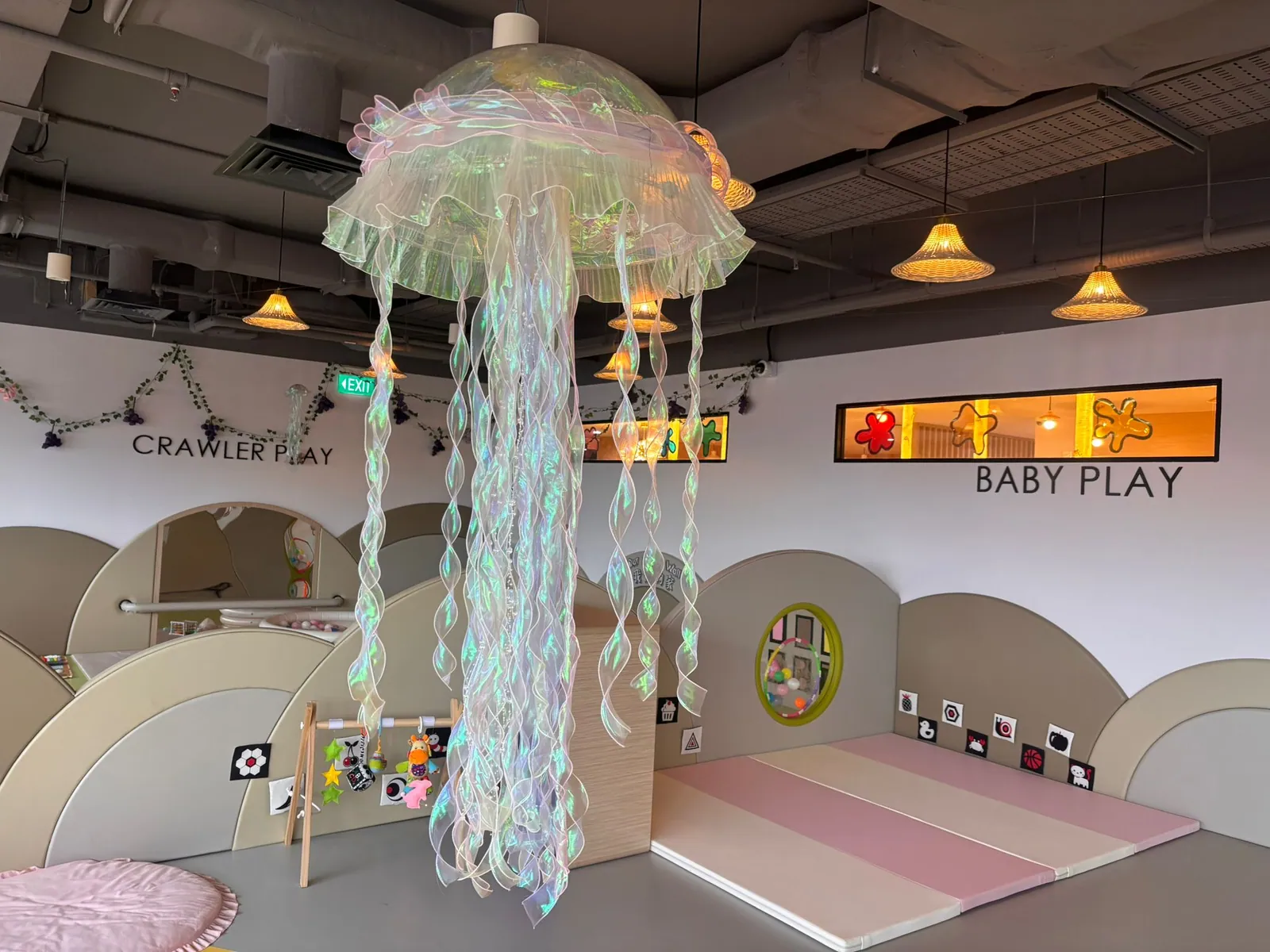 The infant Walker Play room with a tree mural, soft play shapes and the First Touch sensory wall
