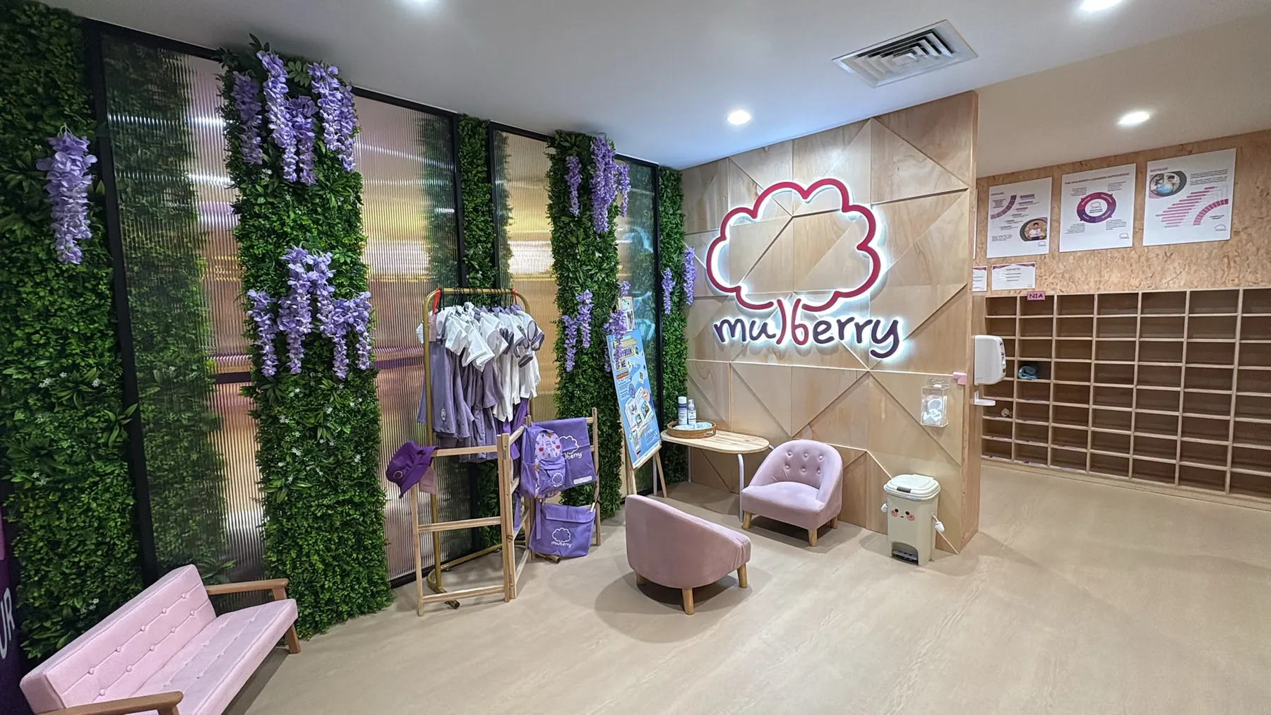 The Mulberry reception with its glowing cloud logo and lush green wall